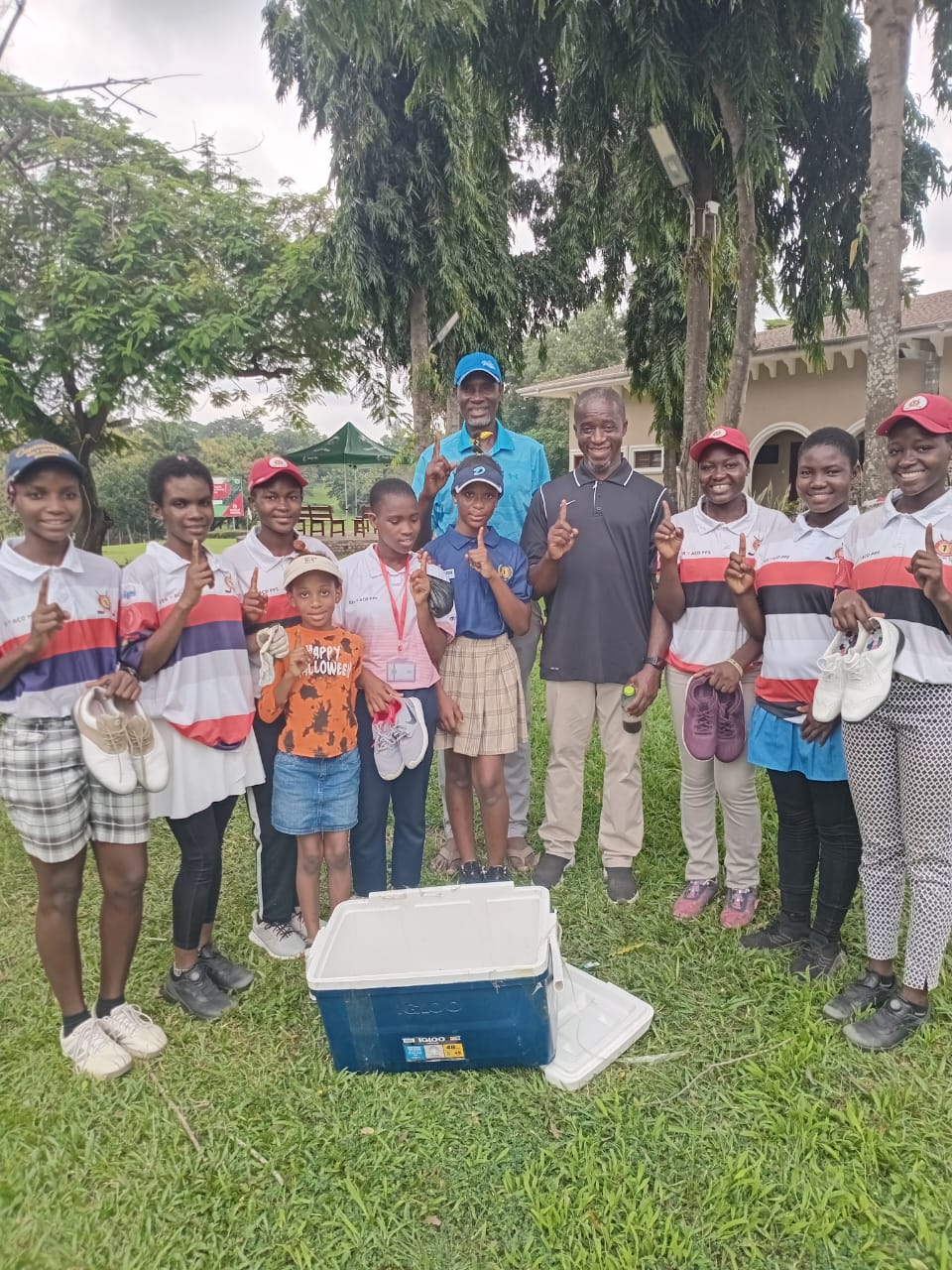 Team Geace President Mr. Theo donating golf equipment to C1GS girls